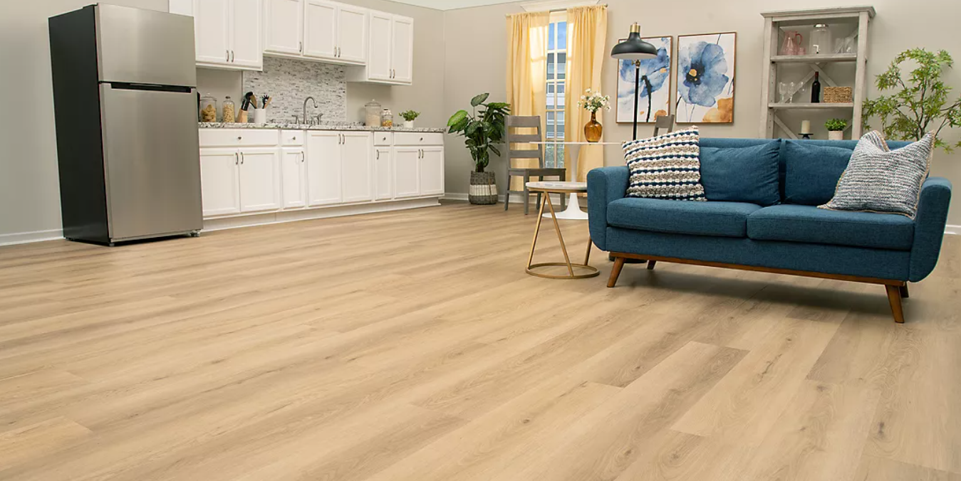 Studio living space with light UltimateFlex vinyl flooring and a blue sofa
