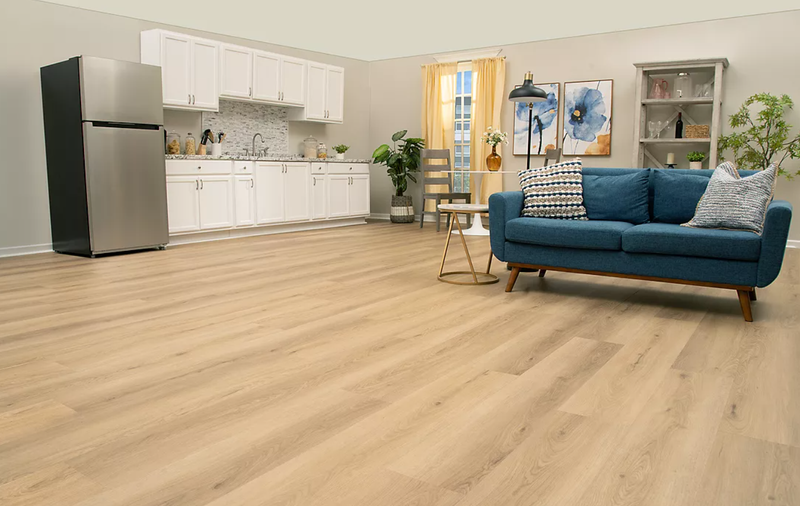 Studio living space with light UltimateFlex vinyl flooring and a blue sofa